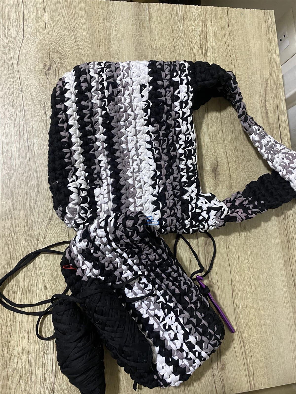 A black and white crochet shoulder bag